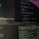 Close-up of software development tools displaying code and version control systems on a computer monitor.