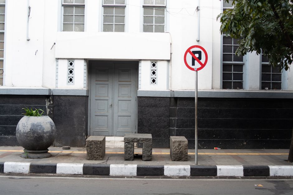 Historic colonial architecture in Bandung, Indonesia with no parking sign in front.