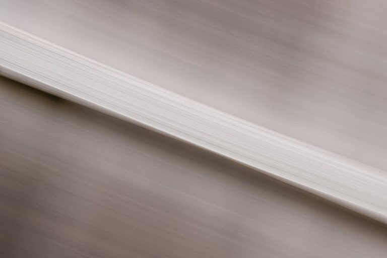Abstract image featuring blurred motion with a white textured pattern.