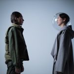 The Alpha of the Avant-Garde: Why ‘Taste Arbitrage’ is the Ultimate Competitive Edge Artistic study of two persons facing each other, one wearing a transparent helmet, in a studio setting.