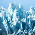 Stunning view of towering iceberg formations under clear blue skies, capturing the essence of winter.