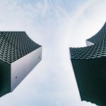 Modern skyscrapers with honeycomb facades showcasing architectural innovation in an urban setting.