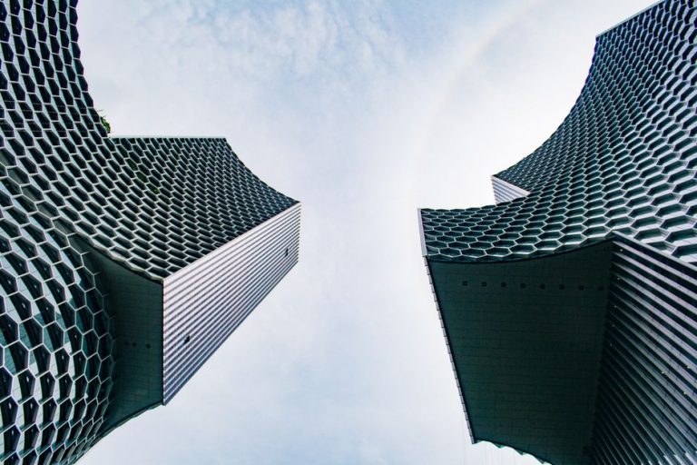 Modern skyscrapers with honeycomb facades showcasing architectural innovation in an urban setting.