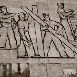The Architecture of Influence: Constructing Institutional Narratives A detailed view of a Soviet-era relief sculpture depicting workers in Budapest, Hungary.