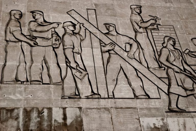 A detailed view of a Soviet-era relief sculpture depicting workers in Budapest, Hungary.