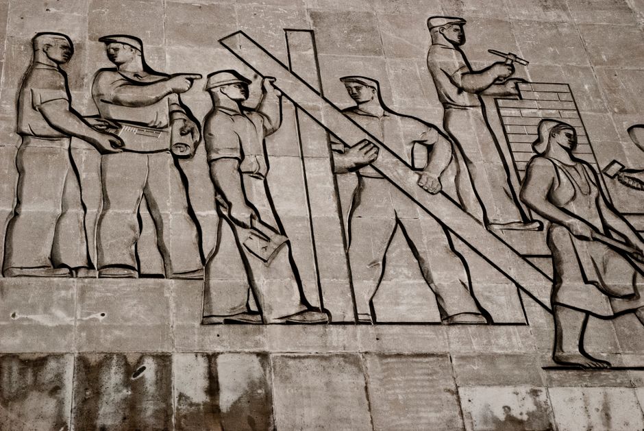 A detailed view of a Soviet-era relief sculpture depicting workers in Budapest, Hungary.