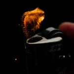 The Architecture of Organizational Friction: Eliminate Bottlenecks A macro shot capturing the ignition spark of a lighter in a dim setting.