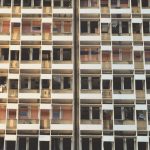 The Architecture of Resilience: Why Decentralization Wins Close-up of a damaged building facade in Beirut, reflecting urban destruction.