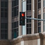 The Architecture of Signal Integrity: Strategy and Autonomy Red traffic light in cityscape setting with modern glass building facade.