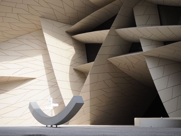 Explore the innovative geometric design of the National Museum of Qatar, capturing unique shadow play.