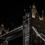 The Architecture of Trust: DLT Governance and Strategy Guide Night view of London’s iconic Tower Bridge with dramatic lighting.