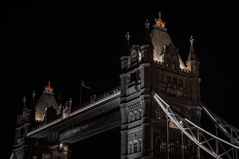 Night view of London’s iconic Tower Bridge with dramatic lighting.