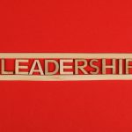 <title>The Bear: Leadership Lessons from the Final Season</title> Wooden letters spelling leadership on a vibrant red background, conveying bold concepts.