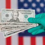 Closeup anonymous person in disposable gloves showing dollars near red and blue flag of United States