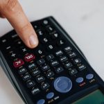 The Calculus of Compassion: Operational Excellence in Altruism From above of crop anonymous economist calculating on calculator with plastic buttons while making budget on marble table