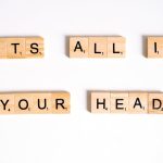 The Cognitive Parasite: Why Your Best Decisions Are Being Hijacked by 'Narrative Mutagens' Wooden Scrabble tiles arranged to spell 'ITS ALL IN YOUR HEAD' on a white background.