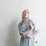 The Dissonance Trap: Why Perfect Harmony Is Killing Your Innovation A woman trapped in spider webs, capturing a sense of entrapment and anxiety.