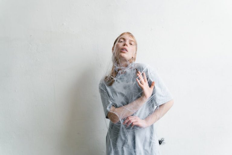A woman trapped in spider webs, capturing a sense of entrapment and anxiety.