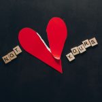 The Emotional Liability: Why Your 'Passion' is Your Biggest Operational Risk A torn red heart with 'Not Yours' spelled in Scrabble tiles on a black background.