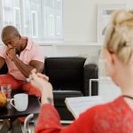 The Empathy Trap: Why Cognitive Over-Analysis Kills Performance Therapist discussing with a client in a mental health counseling session.
