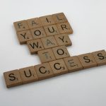 The Failure-First Paradigm: Why Your Business Needs a 'Mission Control' Culture Wooden tiles spell 'Fail Your Way to Success' emphasizing perseverance.