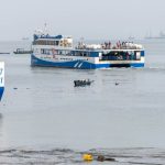 A bustling ferry with passengers departing from Vũng Tàu harbor in Vietnam.
