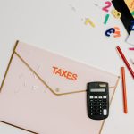 The Friction Tax: Why Your Best Strategy Is Failing Flat lay of a tax preparation workspace with calculator, envelope, and colorful numbers.