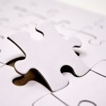 A single white jigsaw puzzle piece fitting into place. Ideal for concepts of problem-solving and solutions.