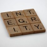 The Integrity Dividend: Why Ethics is Your Most Undervalued Growth Asset Wooden scrabble tiles spelling 'INTEGRITY' on a white background, emphasizing honesty and ethics.