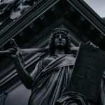Striking statue of Lady Justice holding sword and scales in Dresden, Germany.