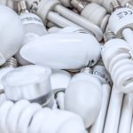 The Lean Fallacy: Why Efficiency is the Enemy of Biological Sovereignty Pile of diverse energy-efficient light bulbs showcasing an array of designs and functionalities.
