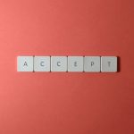 The Myth of Digital Neutrality in Strategic Decision-Making Close-up of keyboard keys spelling 'ACCEPT' on a red background, creating a minimalist and modern design.