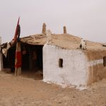 The Nomad’s Trap: Why Your 'Third Place' is Destroying Your Focus Minimalist photo showcasing a traditional nomadic dwelling in a desolate desert environment.