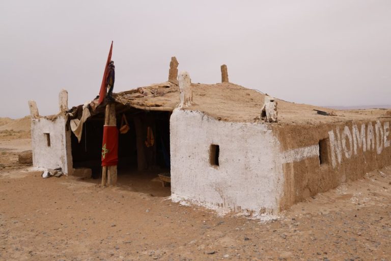 Minimalist photo showcasing a traditional nomadic dwelling in a desolate desert environment.