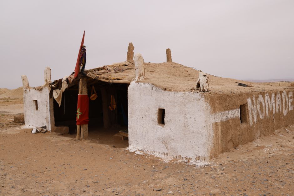 Minimalist photo showcasing a traditional nomadic dwelling in a desolate desert environment.