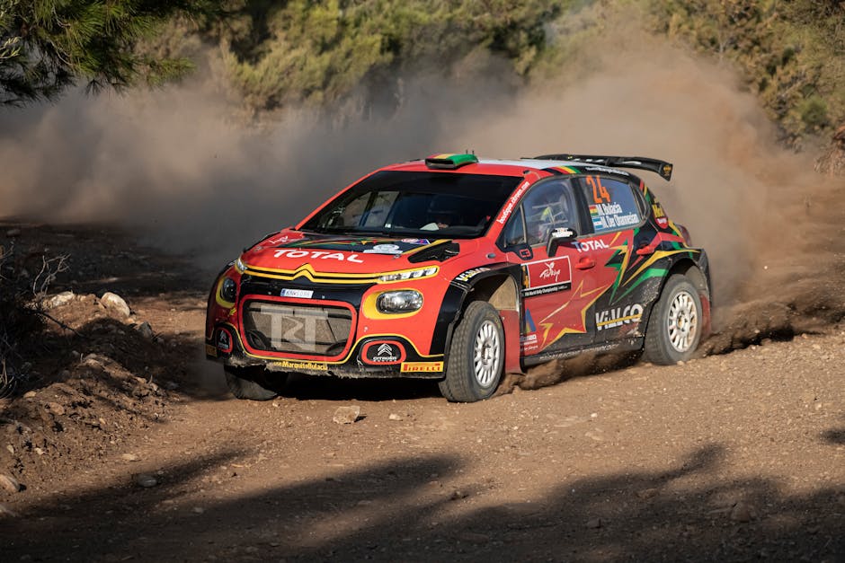 Exciting rally car speeding through a dusty dirt track, capturing the thrill of motorsport racing.