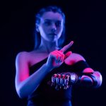 Conceptual photo of a woman using a prosthetic arm, showcasing cutting-edge biotechnology.