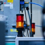 The Productivity Paradox: How Automation Drives Business Growth Detailed view of automated machinery with warning signals in an industrial setting.