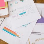 The Quantitative Trap: Why Happiness Metrics Obscure Reality Close-up of business analytics charts and graphs on papers and clipboard.