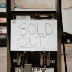 The Scarcity Trap: Why Digital Abundance is Killing Your Brand Value A gas pump at an urban station displaying a 'Sold Out' sign, illustrating fuel shortage.