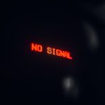 A red LED display indicating 'No Signal' in a dark setting, conveying a tech warning.