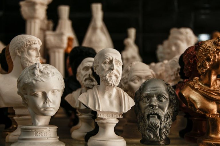 A variety of classical statue busts arranged inside an art studio, showcasing different artistic styles.