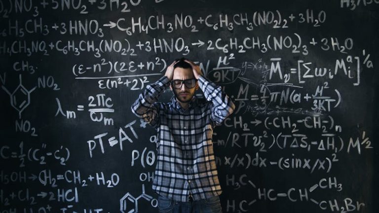 Man in glasses focusing on math problems, struggling with complex equations on chalkboard.