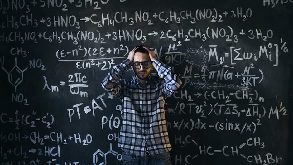 Man in glasses focusing on math problems, struggling with complex equations on chalkboard.