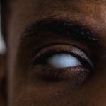 The Stoic’s Blind Spot: Why Too Much Empathy Sabotages Strategy A detailed close-up photograph of an eye with a milky white appearance, representing blindness.