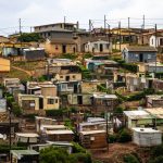The Structural Inequality of Information Access: Bridging Gaps Captivating aerial photo showcasing a densely packed informal housing settlement.