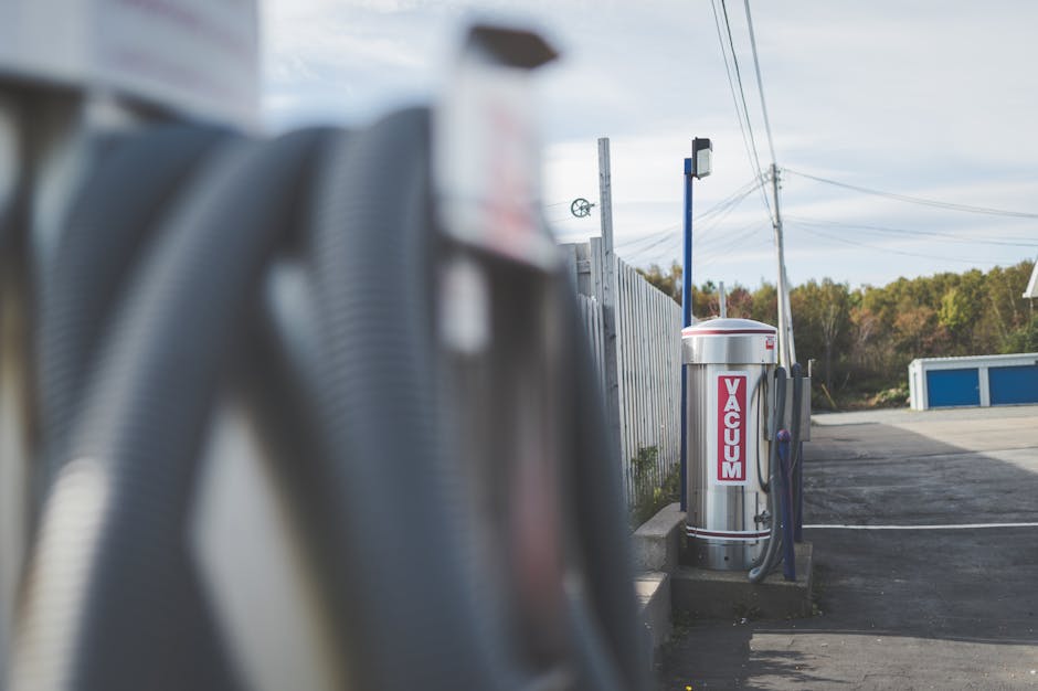 Vacuum station at an outdoor car wash on a clear day with no people around.