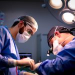 The Surgeon’s Fallacy: Why Leaders Should Practice Strategic Triage Focused surgeons performing a meticulous operation in a hospital operating room.