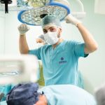 The Surgery Paradox: Why Leaders Must Learn to Amputate A surgeon in scrubs celebrates after a successful surgery in an operating room.