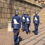 The Uniform Trap: Why Standardizing Your Image May Stifle Strategic Agility Swedish Royal Guards marching at Stockholm Palace on a sunny day.